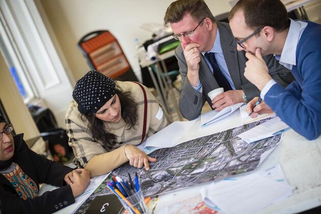 Participants working together over a map as part of a design workshop